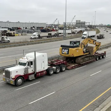 Heavy equipment loaded on a lowboy trailer