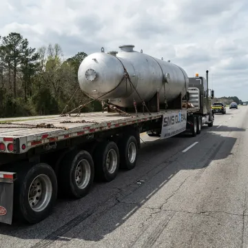 Flatbed truck carrying oversized industrial equipment
