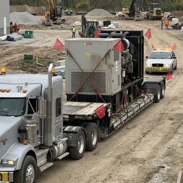 Heavy haul truck transporting an industrial generator