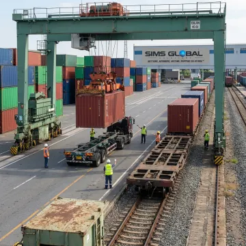 Intermodal freight container transfer at rail terminal