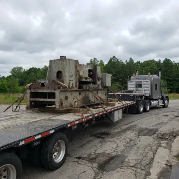 Flatbed truck hauling machinery in Michigan