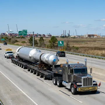 Flatbed truck hauling industrial equipment in Louisiana
