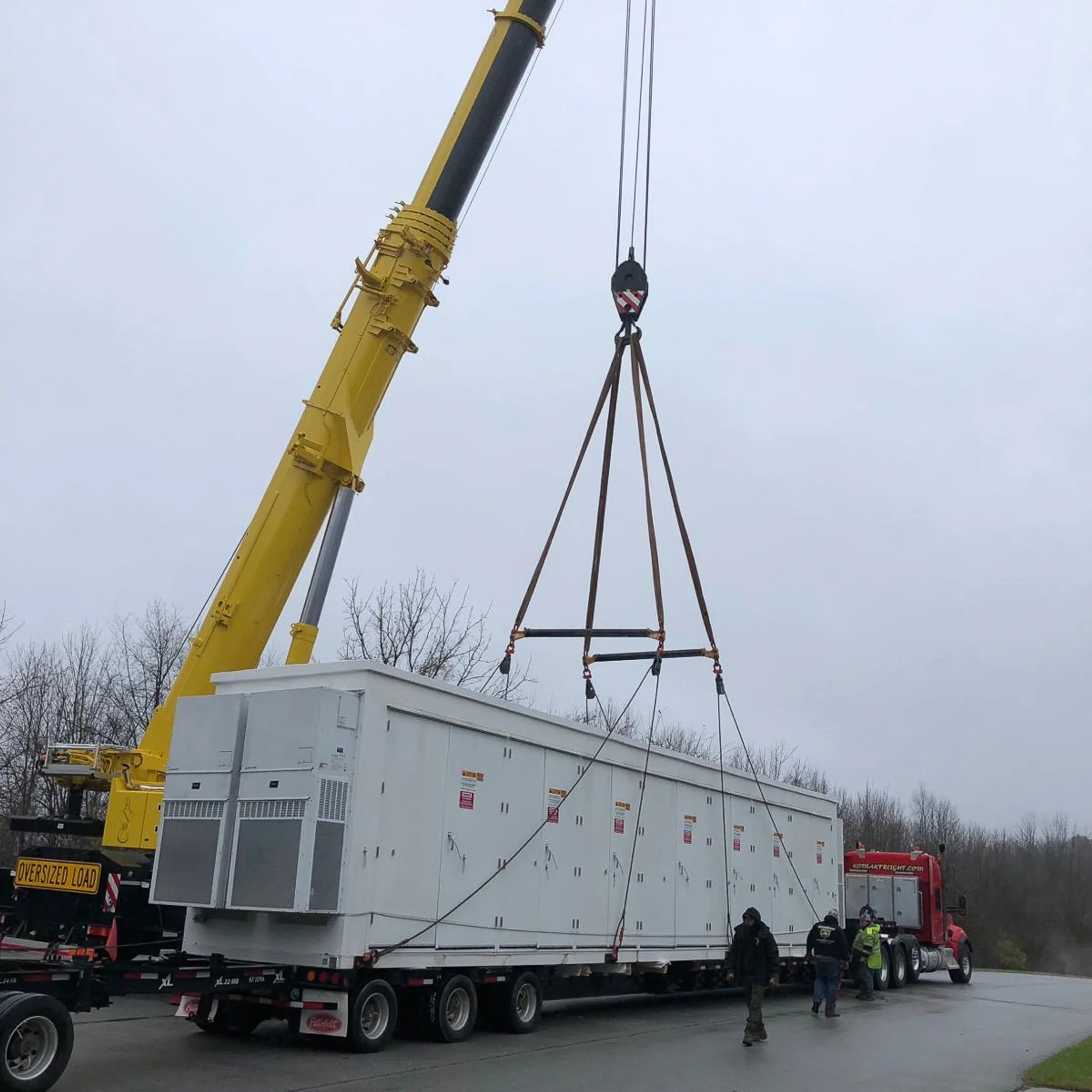 Heavy equipment being loaded onto a lowboy trailer