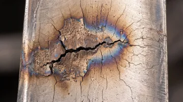 Turbine blade damage from compressor surge and thermal fatigue cracking