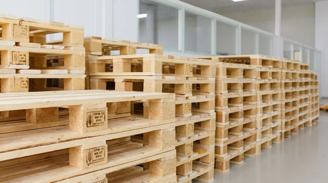 Stacked wooden heat treated pallets in warehouse storage showing structural integrity