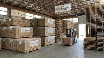 Skid Management Services corner boards and pallets stacked in warehouse