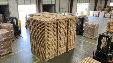 Stacked certified export pallets ready for shipment at supplier facility