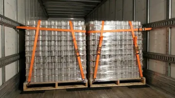 Pallet load secured with stretch wrap ratchet straps and friction mats in freight trailer
