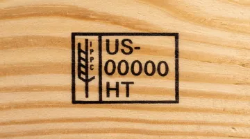 IPPC compliance stamp on wood pallet showing country code and HT treatment mark