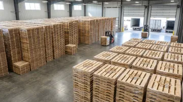 Wood pallets stacked and organized in a shipping warehouse facility