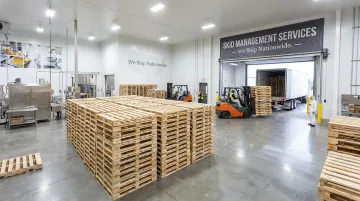 Wood pallets staged in large food manufacturing distribution facility ready for shipment