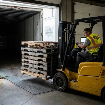 Forklift moving used pallets during removal service