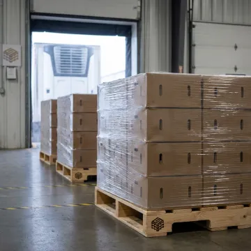 Wood pallets loaded with fresh produce boxes