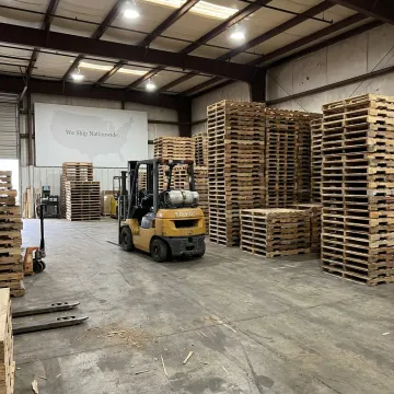 Custom wood pallets stacked in a warehouse