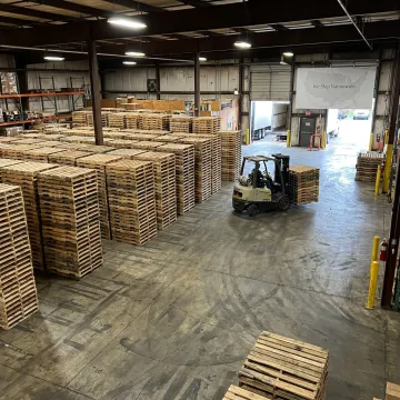 Custom wood pallets stacked in a warehouse