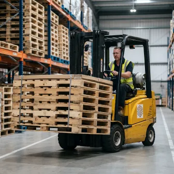 Forklift moving wood pallets