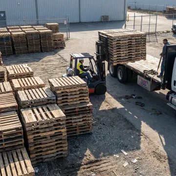 Used wood pallets stacked for warehouse delivery