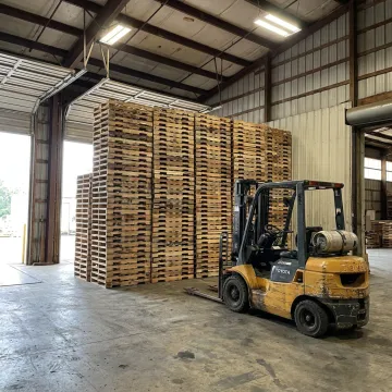 Used wood pallets ready for pickup at warehouse dock