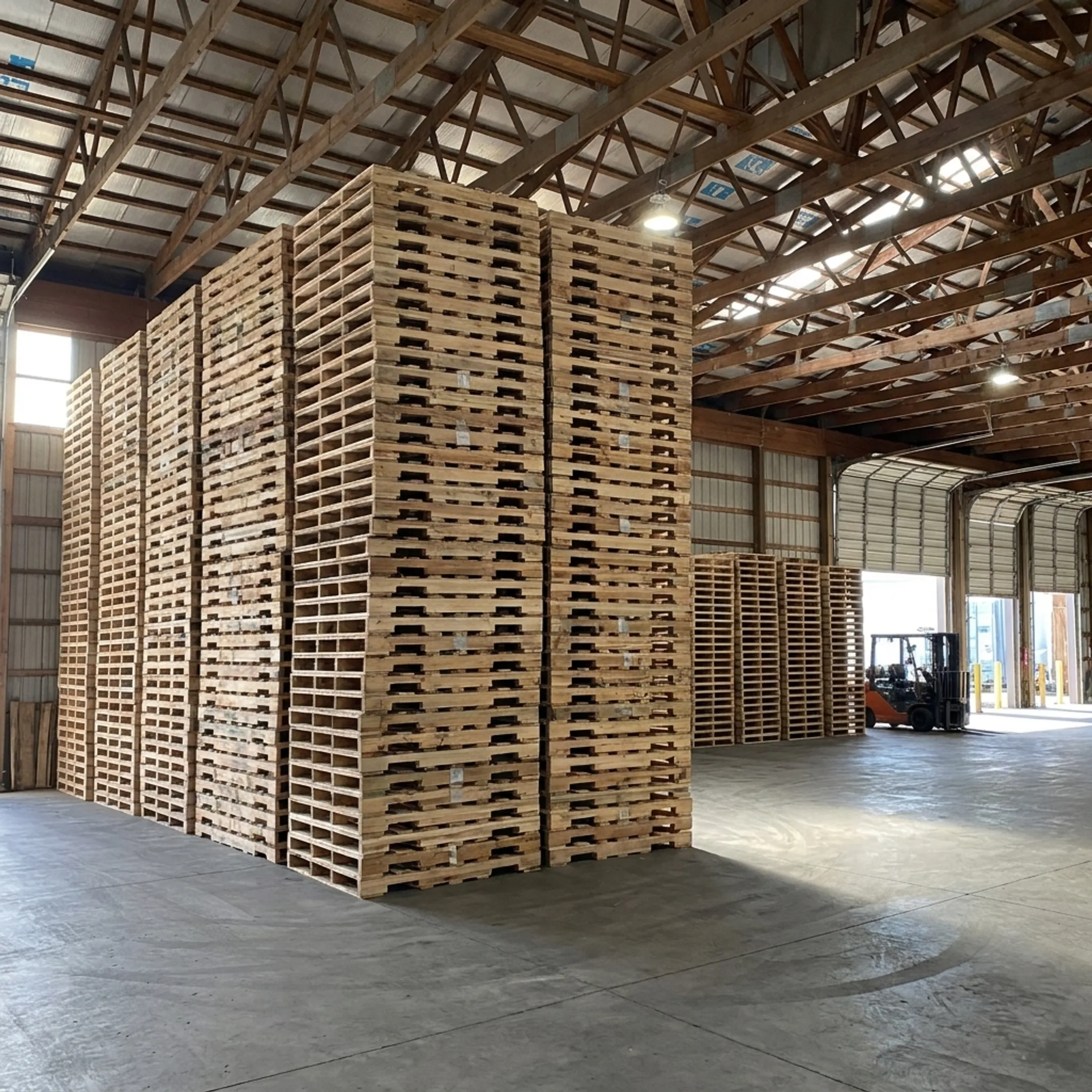 Wood stringer pallets staged in a warehouse