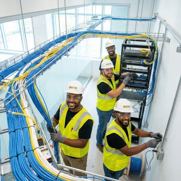 Professional network technicians installing structured cabling infrastructure