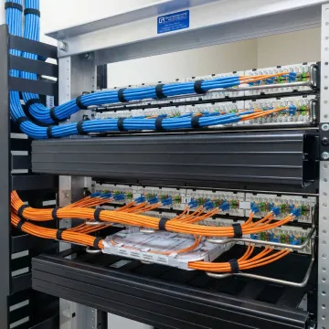 Organized fiber optic cable management in telecommunications room