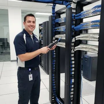 Professional technician installing structured network cabling in modern office environment