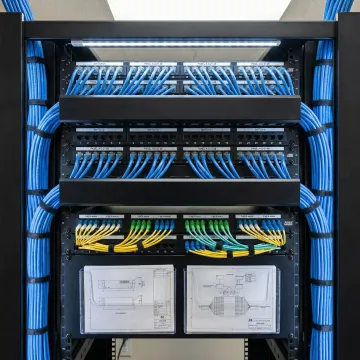 Organized network rack with structured cabling and fiber connections