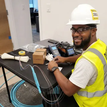 Professional cable installer working with structured cabling systems during BICSI certification training