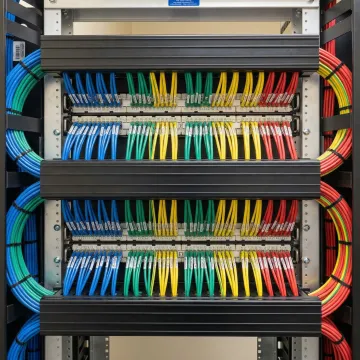 Organized structured cabling installation with neat cable management in professional network closet