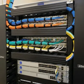 Organized Cat6a network cables in professional server rack installation