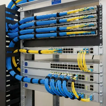 Professional network infrastructure installation with organized cable management and network equipment