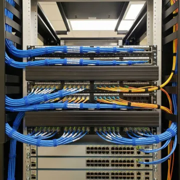 Organized network rack with professionally installed structured cabling and fiber optic connections