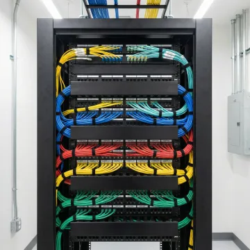 Organized network rack with labeled Cat6 cables and fiber patch panels in Jacksonville office