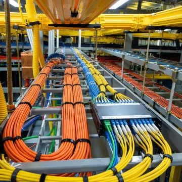 Organized fiber optic cable management in professional network rack installation