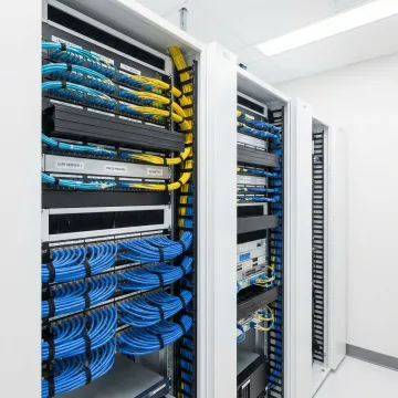Organized healthcare data center with structured cabling and fiber optic infrastructure supporting medical systems