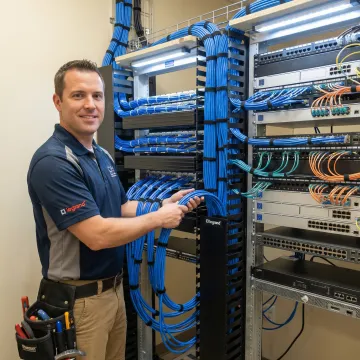 Technician installing Legrand CMK10 cable management in enterprise network room