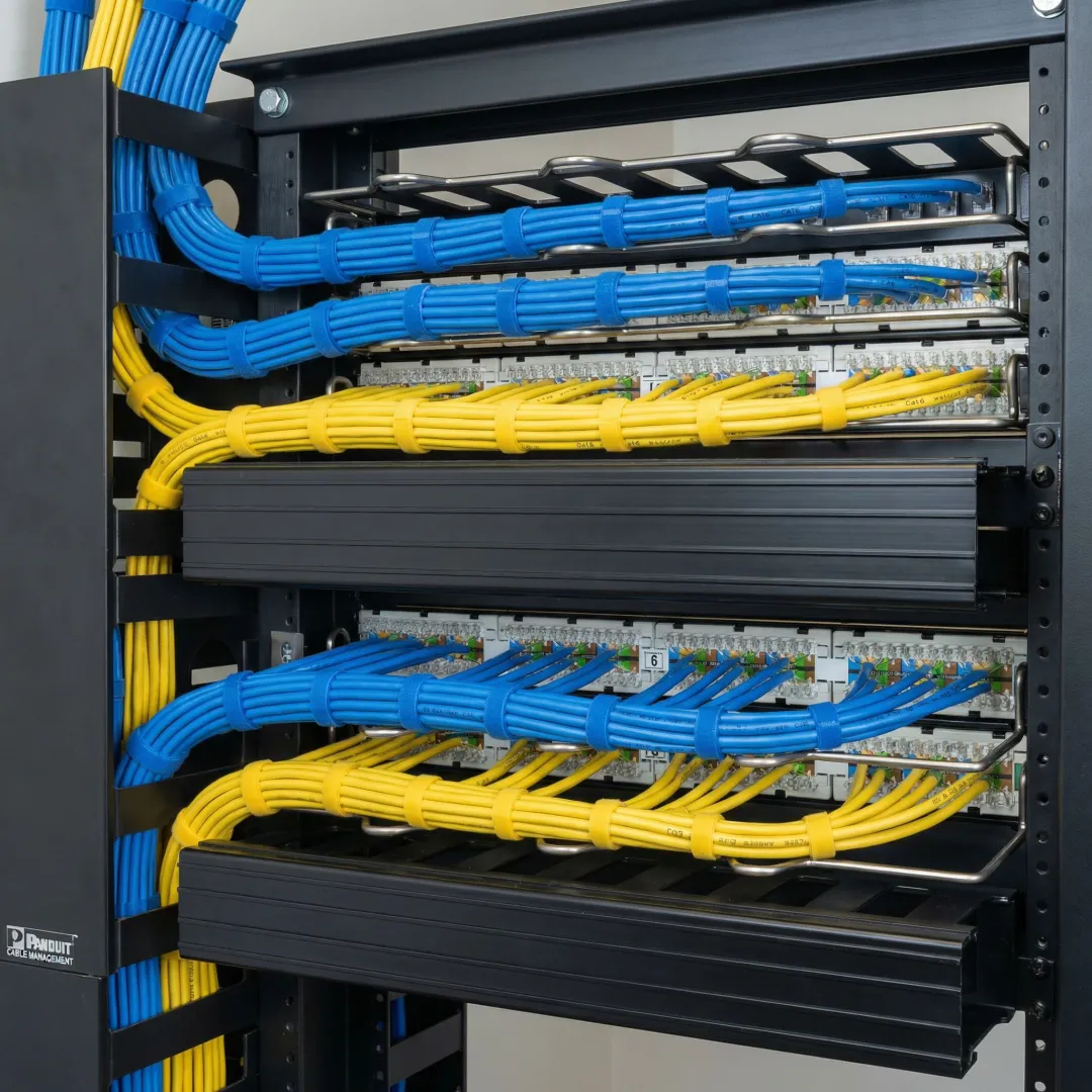 Organized network cabling installation with labeled patch panels and cable management