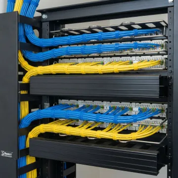Organized network cabling installation with labeled patch panels and cable management
