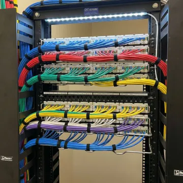 Organized network cabling system with labeled cables and professional cable management in server rack