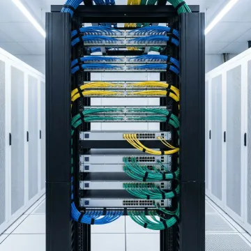 Organized network equipment rack with labeled cables in enterprise environment