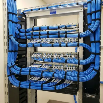 Organized network cable installation with professional labeling in commercial space