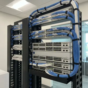 Organized network rack with labeled cables and mounted switches in Atlanta enterprise office