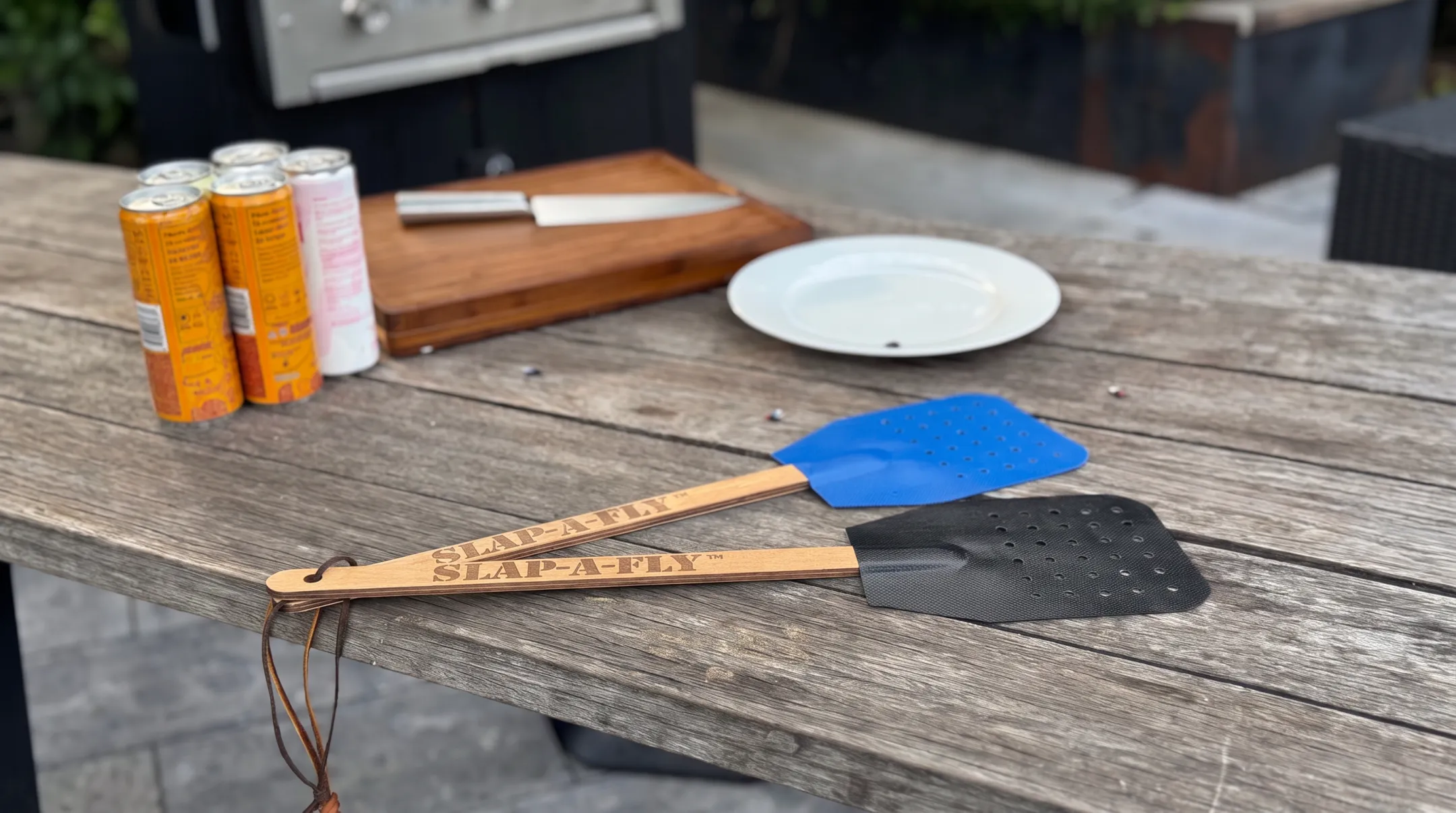 Slap-a-Fly swatter with perforated head and extended handle design