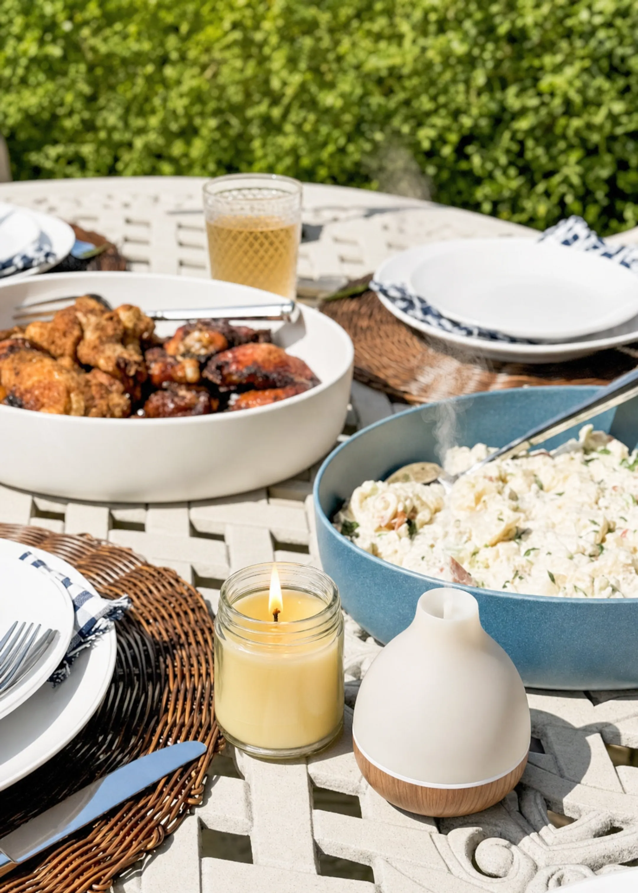 Citronella candle and essential oil diffuser on outdoor dining table