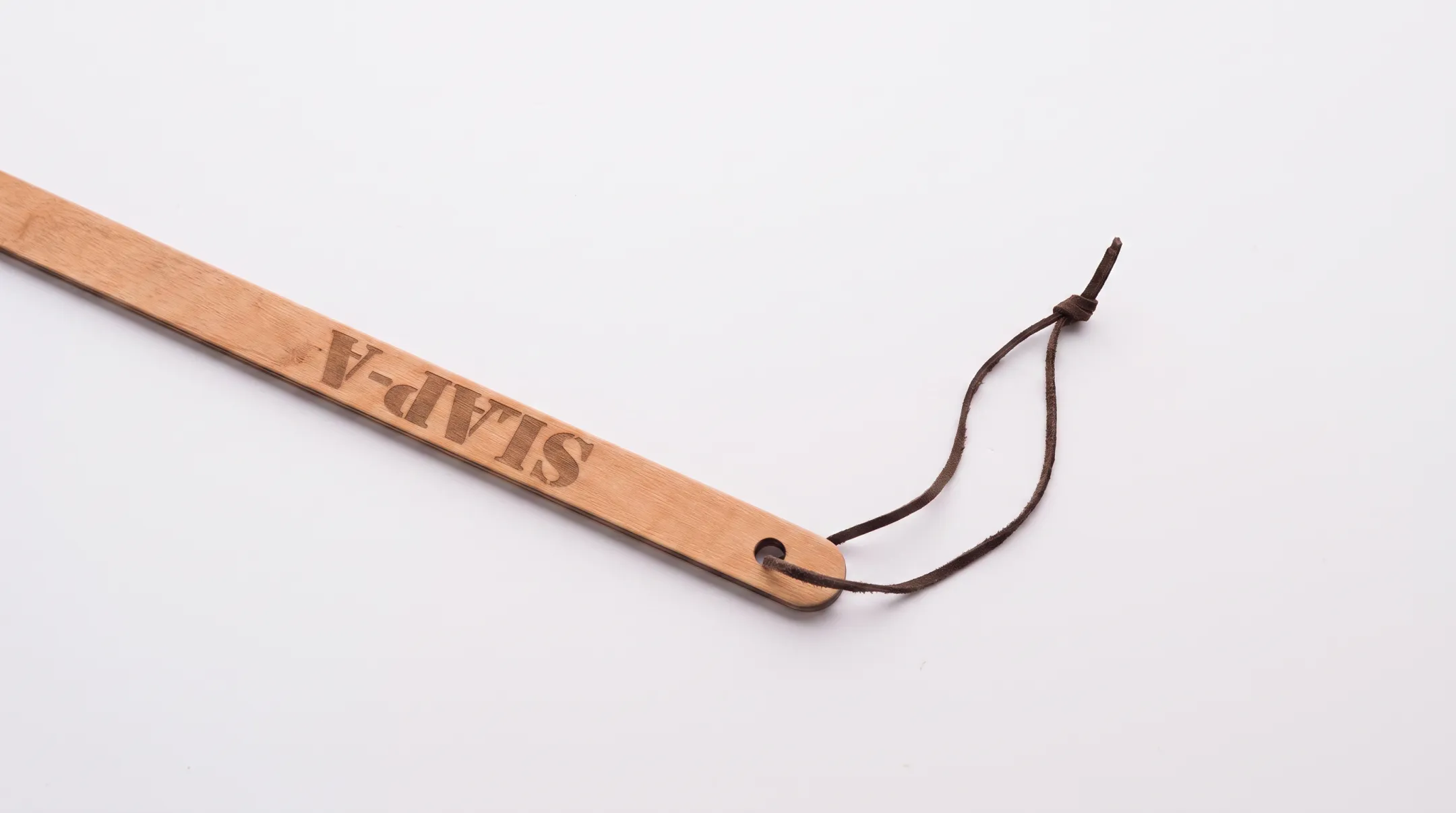 Fly swatter handle showing aircraft spruce wood and storage loop detail