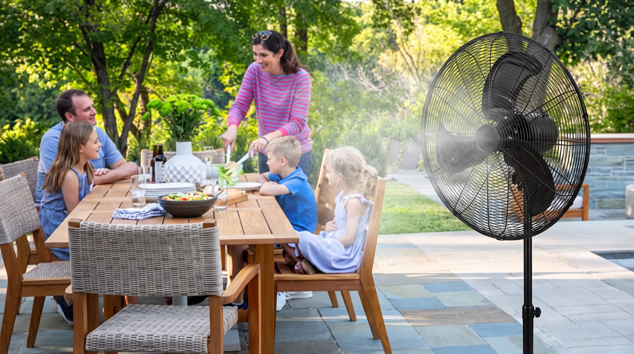 Outdoor fan blowing across patio table to deter flies