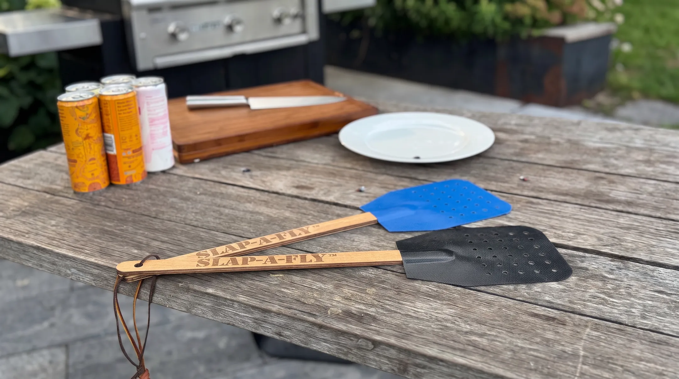 Military-grade flyswatter with Herculite fabric striking surface and spruce handle