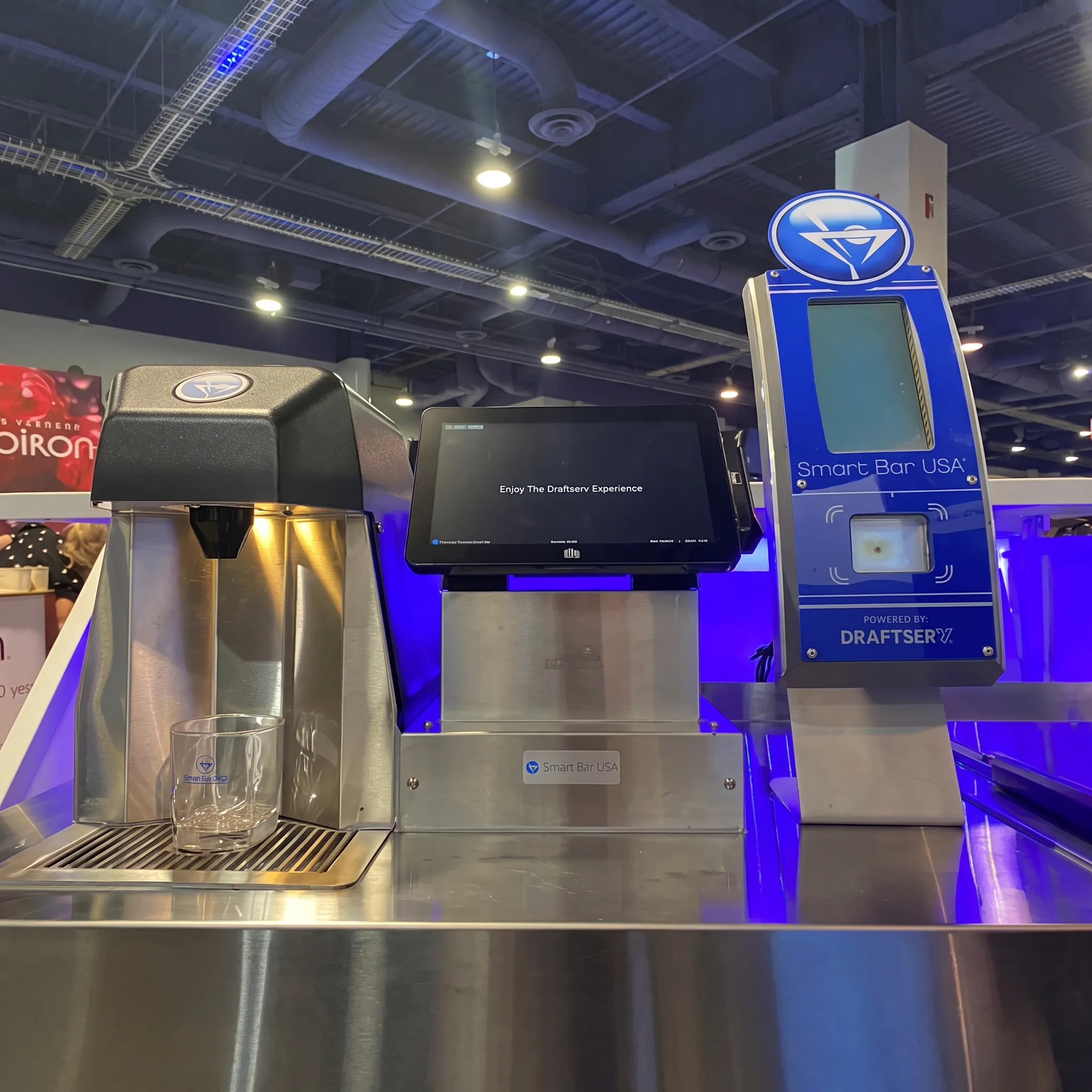 Bar operator managing automated cocktail software on a touchscreen