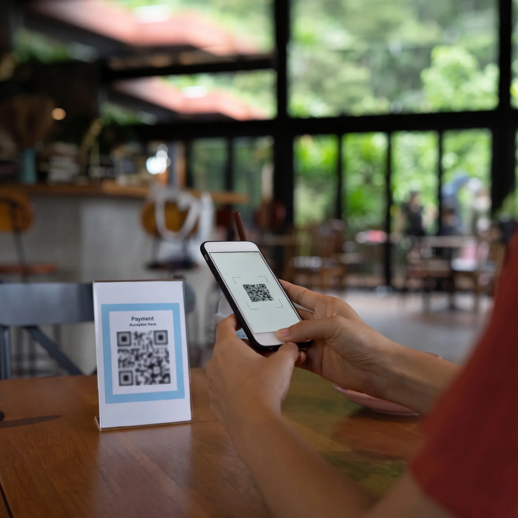 Restaurant guest scanning a QR code menu at a table