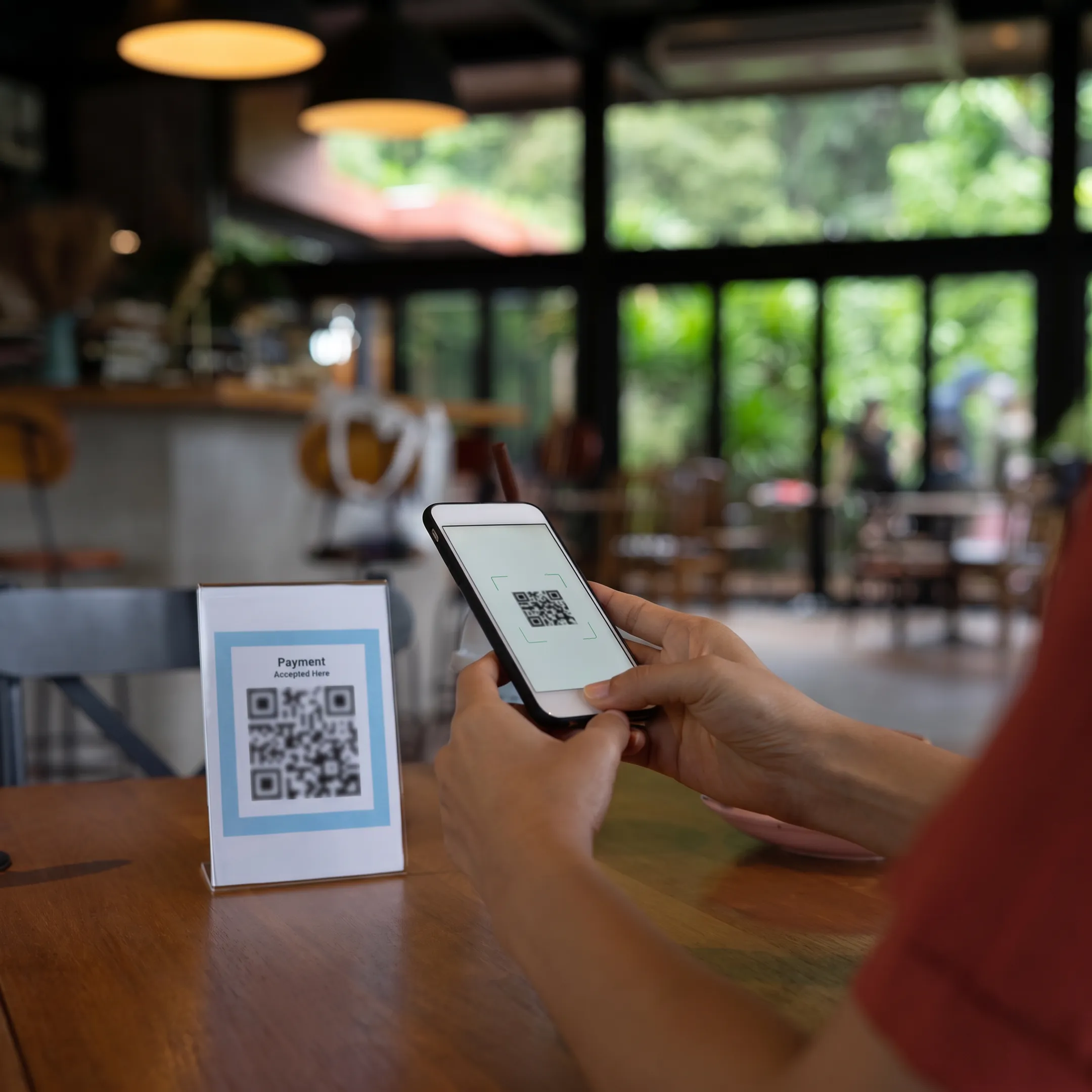 Restaurant guest scanning a QR code to order and pay